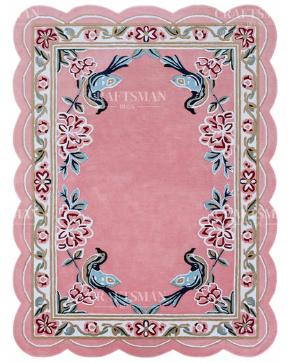 Pink rug with floral and bird designs, featuring the brand 'Craftsman Rugs'.