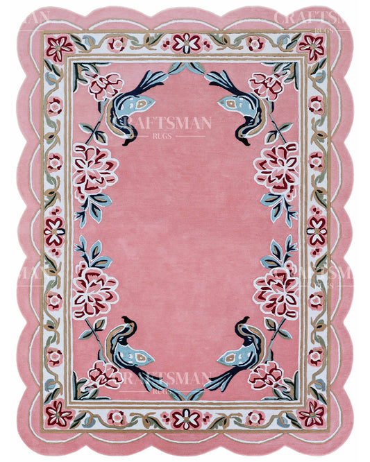 Pink rug with floral and bird designs, featuring the brand 'Craftsman Rugs'.